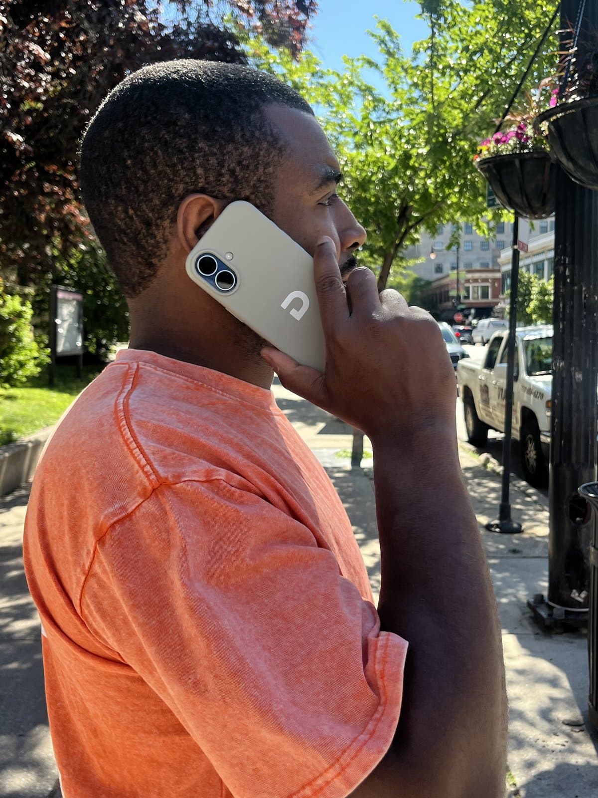 A Dap pre-orderer taking a call with the Dap case in hand, outdoors